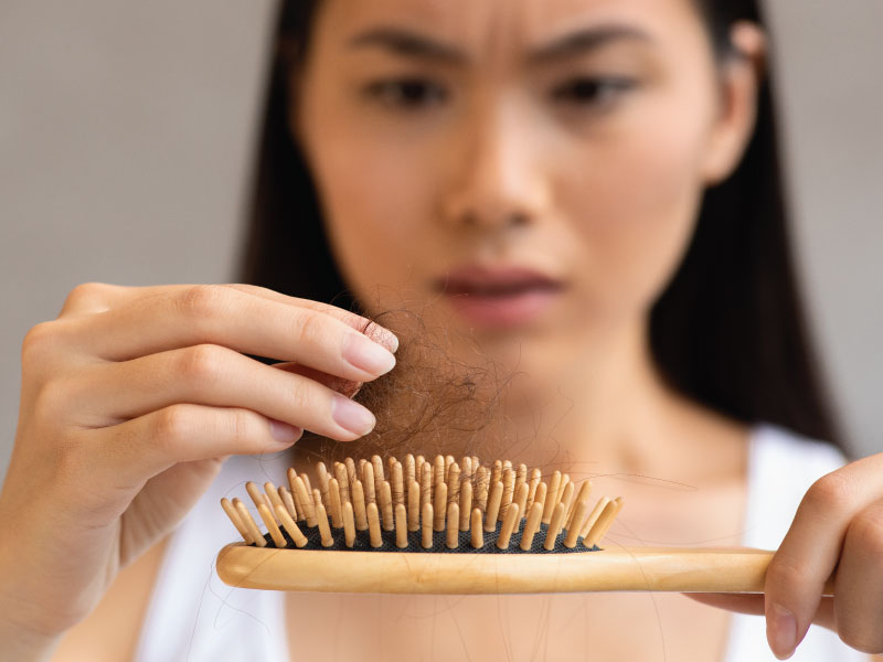 woman upset with hair loss